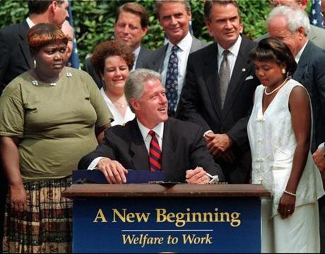 Then-President Bill Clinton in 1996 as he prepared to sign into law legislation that would overhaul America's welfare system.
